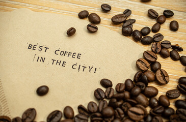 Best coffee in the city slogan on coffee filter with stamps and beans
