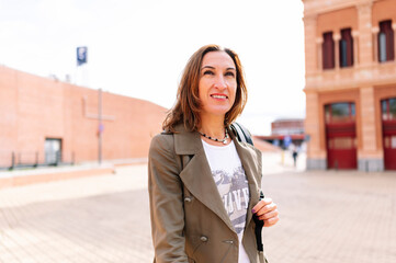 Fototapeta premium Beautiful middle aged woman walking through the city.
