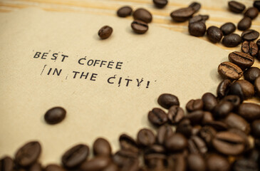 Best coffee in the city slogan on coffee filter with stamps and beans