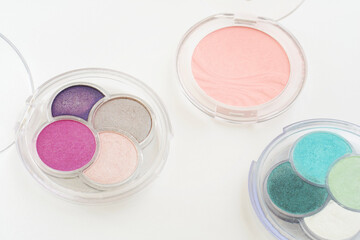 Set of professional makeup and facial cosmetics isolated on white background. Fashion make-up beauty products. Eyeshadow powder flat lay.