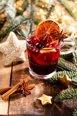 Christmas mulled wine with spices on a wooden rustic table.