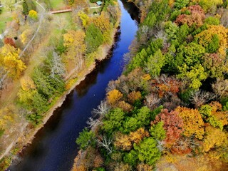 The aerial view of the striking colors of fall foliage by the river near Tunkhannock, Pennsylvania, U.S.A