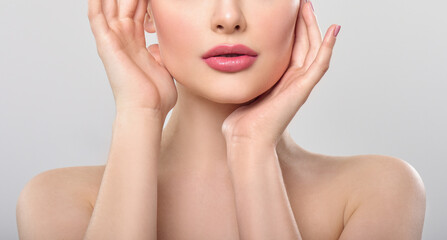 Beautiful face of young adult woman with clean fresh skin. Looking at Camera.