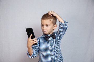 Fototapeta premium Boy with blue eyes on a gray background