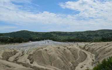 Landscape with cracked soil from Mud Volcanoes, at Paclele Mari, Romania. Volcanic rocks and lava of mud volcanoes. Lunar landscape in Europe