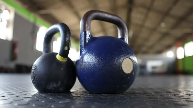 panning footage of kettlebells on a gym floor