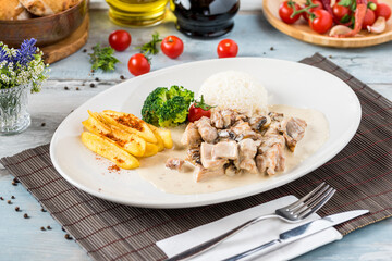 grilled chicken with rice and fried potatoes on white plate