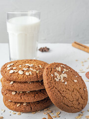 oatmeal cookies and glass of milk on white concrete background