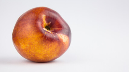 Fresh juicy peaches on a white plate. Close-up Fresh organic peaches nectarine on a white plate.