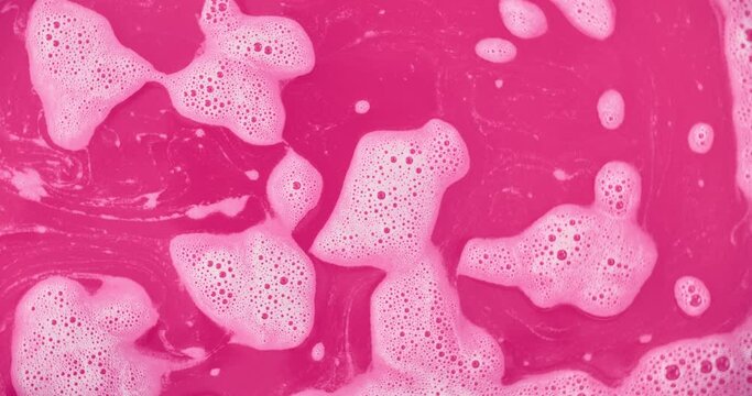 Purple Pink Magenta Water Liquid Soda Swirling and Floating with Bubbles and Foam