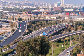 Aerial view of highway and convergence of roads, bridges with moving cars.