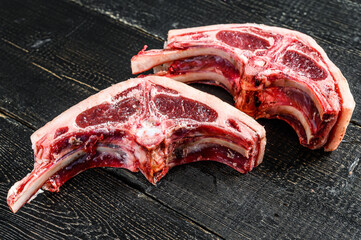 Raw lamb cutlets fresh cut . Black background. Top view