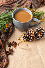 Obraz na płótnie Canvas A Cup of coffee or cocoa with Christmas tree or New year decor. Winter still life with a warm drink, scarf, anise stars and cones copy space