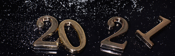 Metal numbers 2021 on a dark background, an elongated panorama