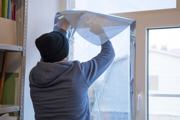 Installing window film in the office. Protection from ultraviolet radiation. Protective film.