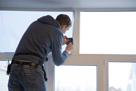 Installing window film in the office. Protection from ultraviolet radiation. Protective film.