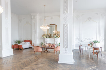 royal baroque style luxury posh interior of large room. extra white, full of day light. high ceiling and walls decorated by stucco