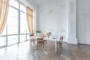 royal baroque style luxury posh interior of large room. extra white, full of day light. high ceiling and walls decorated by stucco