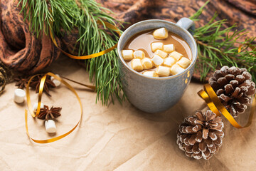 Obraz na płótnie Canvas A Cup of coffee or cocoa with marshmallows with Christmas tree or New year decor. Winter still life with a warm drink, scarf, anise stars and cones