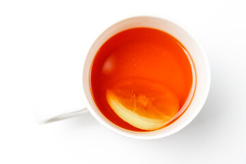Tea with lemon in a cup on a white background