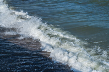 Fototapeta premium Sea wave with foam and splashes, close up, copy space