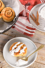 Cinnamon buns with chocolate chips baked in a cast iron pan overhead shot