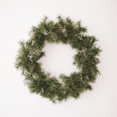 Wreath of spruce on white background. Christmas decorations. New Year holiday composition. Frame wreath mock up. Copy space 