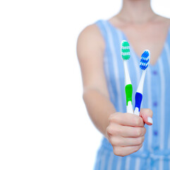 Woman holding toothbrush in hand on white background isolation