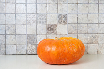 Halloween holiday. Orange pumpkin in the kitchen