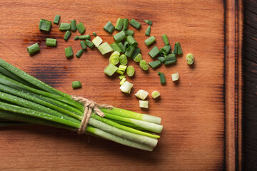 Chives feathers chopped on a board, close up