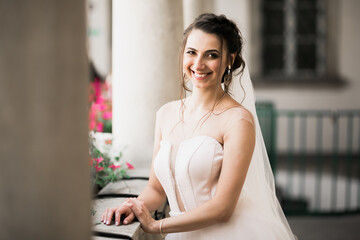 Beauty portrait of bride wearing fashion wedding dress with feathers with luxury delight make-up and hairstyle