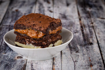 Chocolate brownie with milk powder delicious filling. Closeup photography.