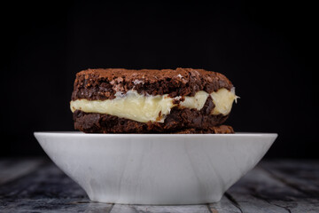 Chocolate brownie with milk powder delicious filling. Closeup photography.