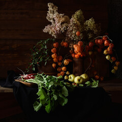 Vegetables and fruits next to a jug of physalis.