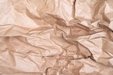 Old crumpled paper surface. brown Kraft paper texture background.
Selective focus. Texture.