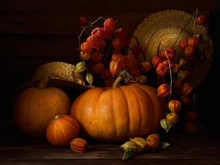 Pumpkins and physalis and straw hats.