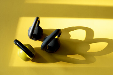 three kettlebells on the yellow floor