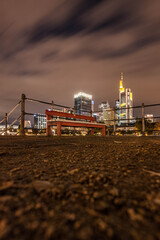 Fototapeta na wymiar bench in the foreground of Frankfurt skyline at night 