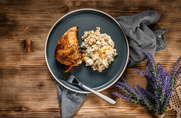 Roast chicken served with russian traditional salad.