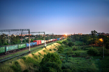 Obraz premium Train with freight cars while moving in the evening