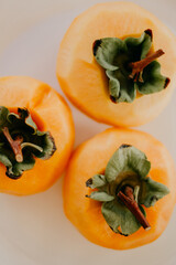Close up of peeled khakis fruit. Persimmons