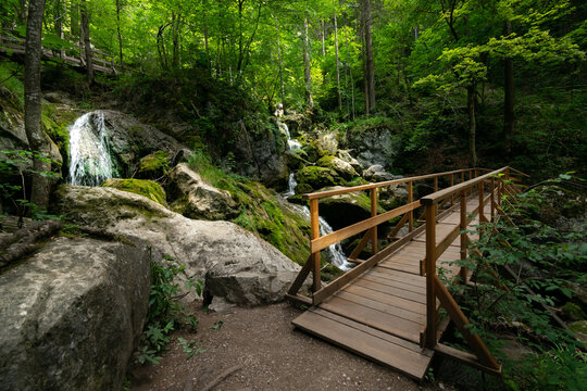 Wooden walking bridges and majestic waterfalls in water land of Myra Valley. Lower Austria, 9th July 2020.