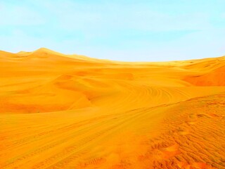 Fototapeta na wymiar Bright yellow orange color sand dunes in desert against blue clear heaven in golden peaceful desert. Solitude landscape and meditation nature. Dry arid hot climate. Sun and sky.