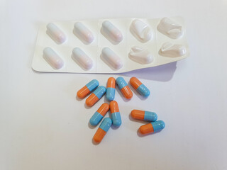 close-up on a white background red and blue capsules in a blister, started packaging 