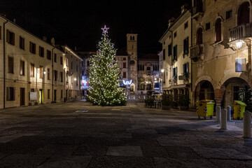 Naklejka premium View on Christmas tree in beautiful medieval town square, Vittorio Veneto, Italy. Concept: Italian historic centers, urban panoramas, urban Christmas decorations