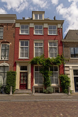 Fototapeta na wymiar Typical traditional masonry house with front garden with climbing plant in the city of Utrecht, the Netherlands 