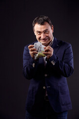 Senior aged business man holding euro bills.