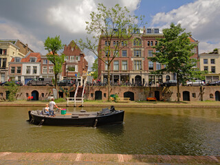 `old canal` in Utrecht, with typical dutch houses, with cellars coming out on an old wharf