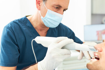 Senior dentist holding 3d scanner