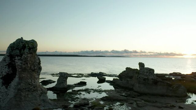 Pan aerail shot of Rauks sea stacks, limestones, in Gotland, Sweden,